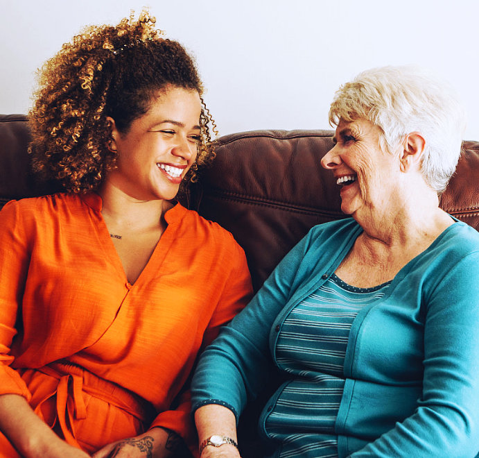 woman and elderly woman smiling