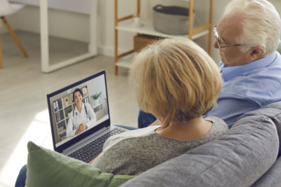 two elderly looking at the laptop