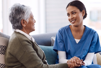 nurse and elderly woman talking