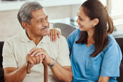 nurse and elderly man talking