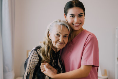 nurse and elderly woman hugging