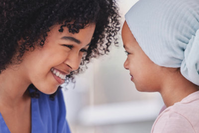 nurse and child holding hands