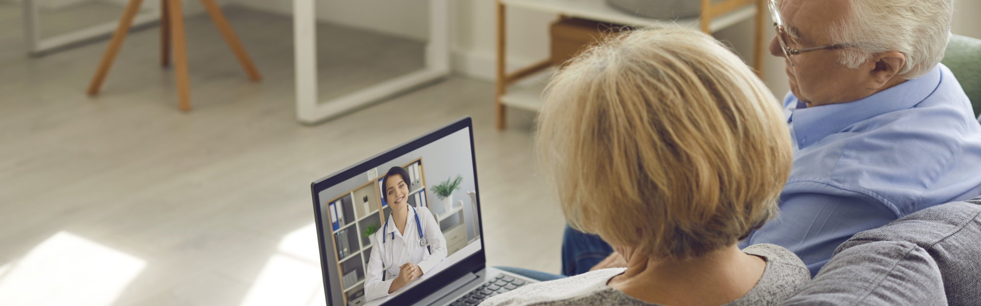 two elderly looking at the laptop