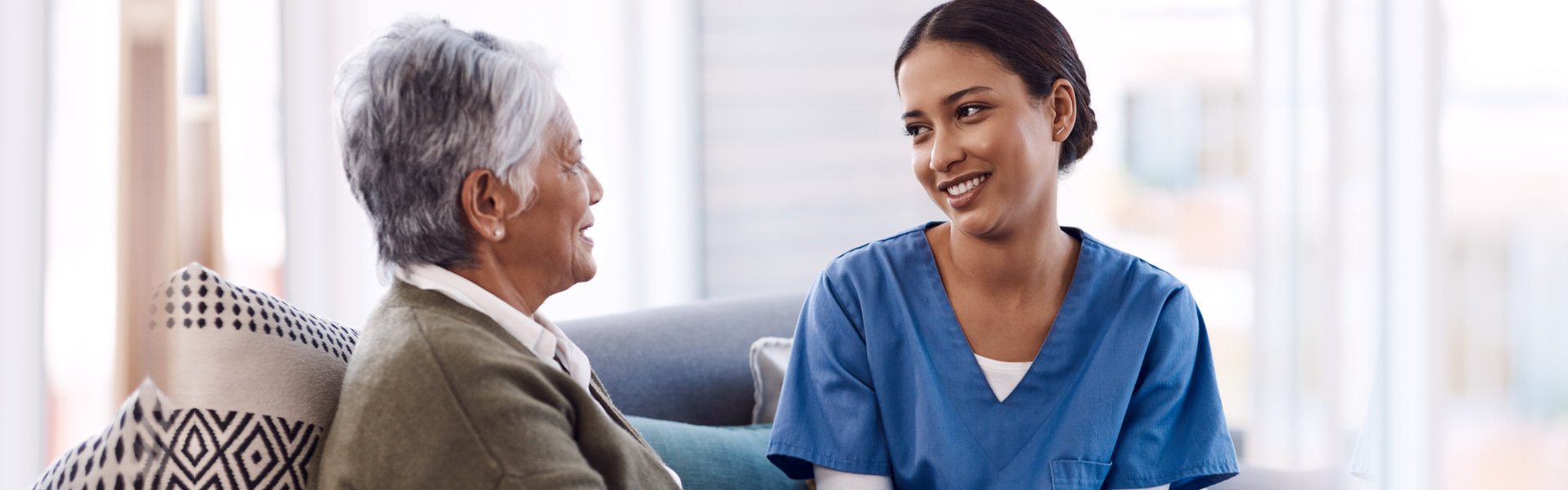 nurse and elderly woman talking