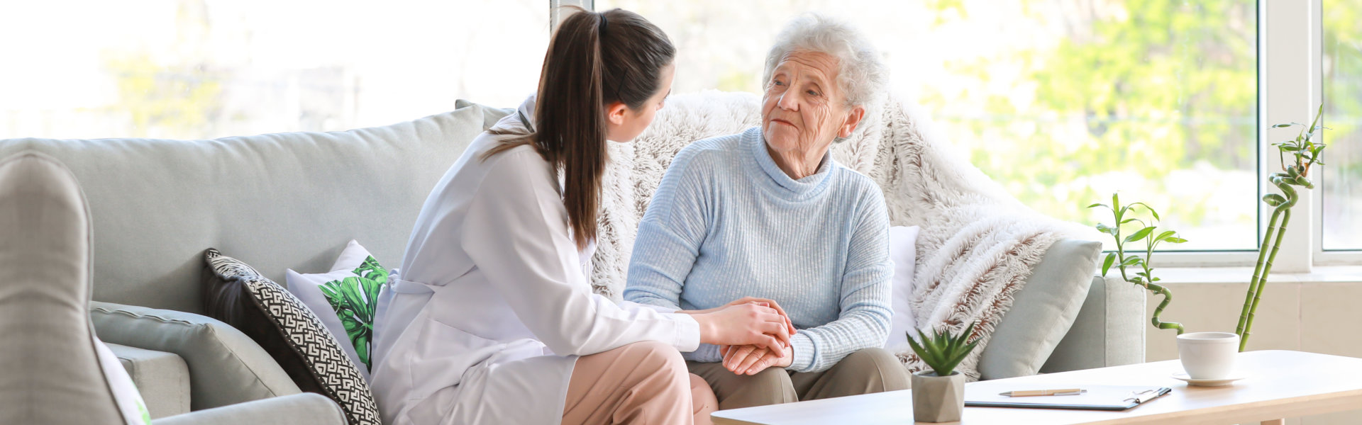 nurse and elderly woman looking at each other