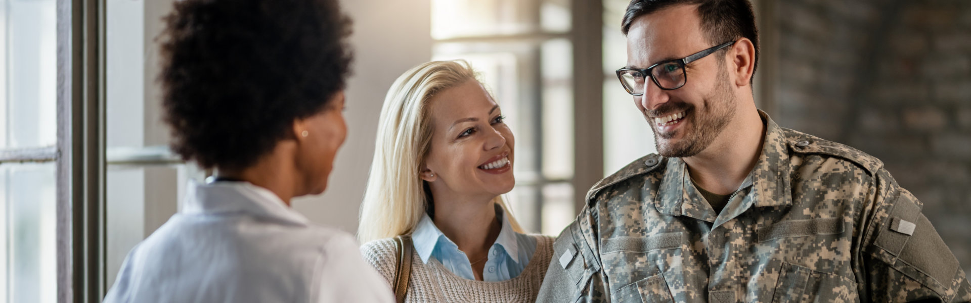 Happy military man shaking hands with female doctor