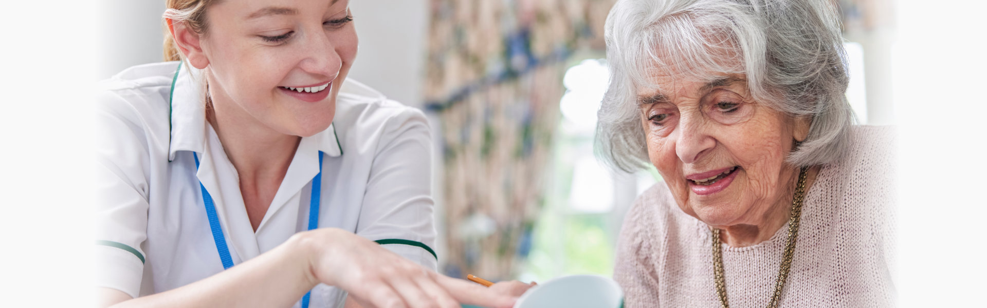 Senior Woman Painting Cup With Art Therapist