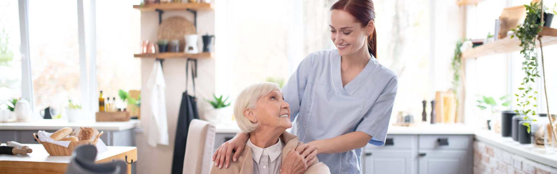 nurse and elderly woman looking at each other