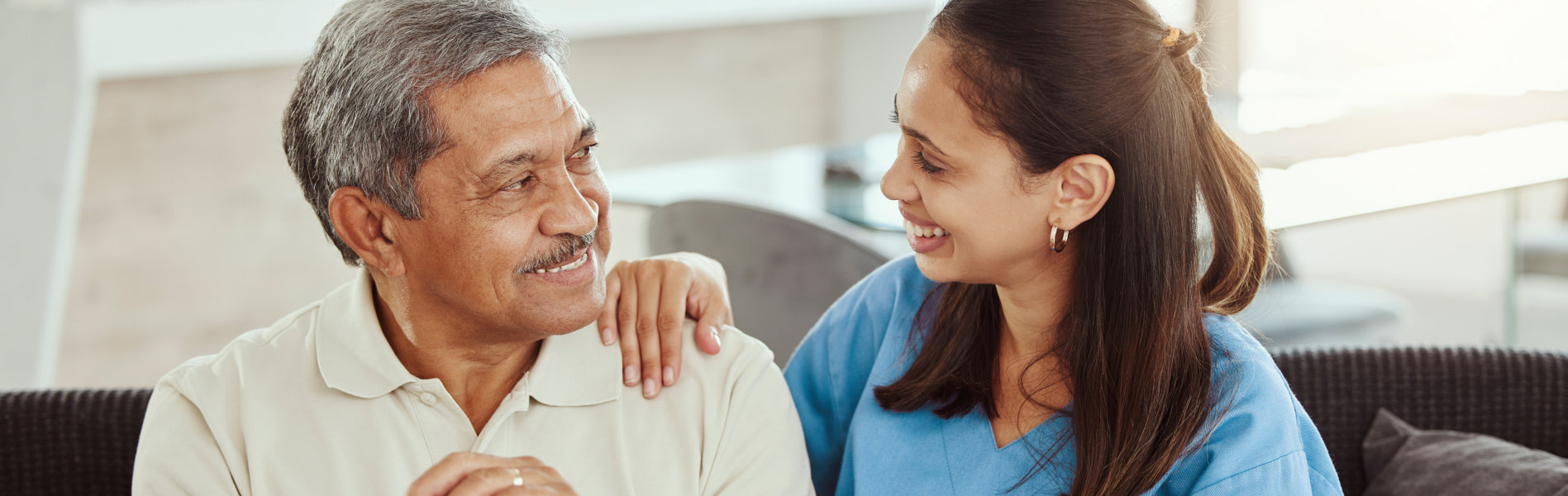 nurse and elderly man talking